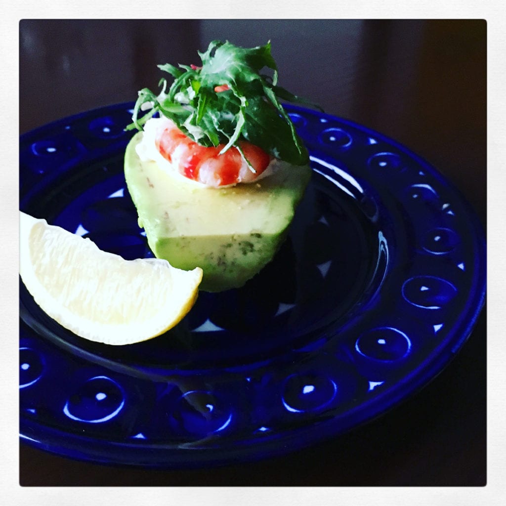 Avocado salad made with boiled shrimp, chopped celery and onion, sour cream